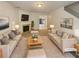 Staged living room with fireplace, light colored sofas and walls creating an inviting and comfortable ambiance at 6240 Shenfield Ln, Union City, GA 30291