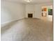 Neutral toned living room with a fireplace and view of the eat-in kitchen at 6240 Shenfield Ln, Union City, GA 30291