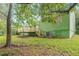 Backyard view of a green home with a wooden deck, stairs, and air conditioning unit at 1249 Riva Ridge Dr, Norcross, GA 30093