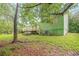 Backyard view of a green home with a wooden deck, stairs, and air conditioning unit at 1249 Riva Ridge Dr, Norcross, GA 30093