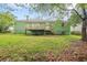 Backyard view of a green home with a wooden deck, stairs, and air conditioning unit at 1249 Riva Ridge Dr, Norcross, GA 30093