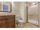 Bathroom featuring dark wooden vanity, a mirror, and a shower with a glass door at 1249 Riva Ridge Dr, Norcross, GA 30093