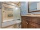 Bathroom featuring tile floor, tiled shower with glass doors and decorative tile border at 1249 Riva Ridge Dr, Norcross, GA 30093