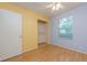 Bedroom features a closet, yellow and blue walls, and a window overlooking the backyard at 1249 Riva Ridge Dr, Norcross, GA 30093