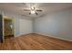 Bedroom featuring hardwood floors, a closet with doors, and a ceiling fan at 1249 Riva Ridge Dr, Norcross, GA 30093