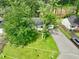 This single-story home features a well-kept lawn, driveway, and is shaded by mature trees at 1249 Riva Ridge Dr, Norcross, GA 30093
