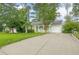 Charming single-story home with a long driveway, attached garage, and lush front lawn at 1249 Riva Ridge Dr, Norcross, GA 30093