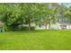 Well-maintained lawn and mature trees frame this charming single-story home's exterior at 1249 Riva Ridge Dr, Norcross, GA 30093