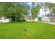 Well-maintained lawn and mature trees frame this charming single-story home's exterior at 1249 Riva Ridge Dr, Norcross, GA 30093