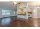 Open-concept living room with hardwood floors, and kitchen view and bar seating at 1249 Riva Ridge Dr, Norcross, GA 30093