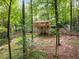 Home nestled among trees, showcasing a large deck, inviting the serenity of nature right to the doorstep at 2880 Foothill Trl, Marietta, GA 30066