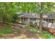 A charming home with red shutters, surrounded by mature trees and landscaped gardens at 2880 Foothill Trl, Marietta, GA 30066