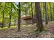 Exterior of the home featuring a wooden deck surrounded by a lush green treeline on a hillside at 2880 Foothill Trl, Marietta, GA 30066