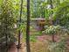 A home nestled amongst the trees with lush landscaping, a wooden deck and an inviting appeal at 2880 Foothill Trl, Marietta, GA 30066