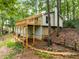 Charming home featuring a spacious wooden deck nestled among lush trees, offering a serene and private outdoor space at 2880 Foothill Trl, Marietta, GA 30066