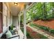 Inviting front porch with seating, surrounded by lush greenery and a winding stone path to the home at 2880 Foothill Trl, Marietta, GA 30066