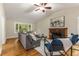 Comfortable living room with vaulted ceilings, a fireplace, and a large window overlooking the backyard at 2880 Foothill Trl, Marietta, GA 30066