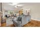 Open-concept living room features a fireplace, hardwood floors, and windows overlooking the backyard at 2880 Foothill Trl, Marietta, GA 30066