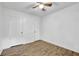 Bedroom features wood-look floors, two closets, a ceiling fan, and neutral paint at 5012 Galbraith Cir, Stone Mountain, GA 30088