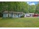 Picture of a cozy light blue home with white trim, green yard and an attached garage at 5012 Galbraith Cir, Stone Mountain, GA 30088