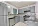 Updated kitchen featuring gray cabinets, stainless steel appliances, and decorative tile backsplash at 5012 Galbraith Cir, Stone Mountain, GA 30088