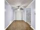 Bright living room with hardwood floors, ceiling fan and a painted closet and window at 5012 Galbraith Cir, Stone Mountain, GA 30088