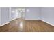 Expansive living room with glossy hardwood floors and neutral wall color for personalization at 5012 Galbraith Cir, Stone Mountain, GA 30088