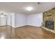 Spacious living room featuring hardwood floors and a stone fireplace for a cozy ambiance at 5012 Galbraith Cir, Stone Mountain, GA 30088