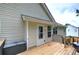 Wooden back deck featuring black railings and a door to the home at 121 Paradise Circle, Douglasville, GA 30134