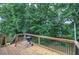 Wooden back deck with view of yard, wooden railings, and barbecue grill at 121 Paradise Circle, Douglasville, GA 30134