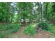 Wooded backyard offering privacy and a serene setting with a wooden privacy fence at 121 Paradise Circle, Douglasville, GA 30134