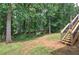 Expansive backyard featuring lush greenery and a newly installed wooden staircase for backyard access at 121 Paradise Circle, Douglasville, GA 30134