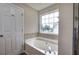 Bathroom with large soaking tub and large window at 121 Paradise Circle, Douglasville, GA 30134