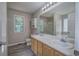 Bathroom featuring double vanity sinks, large mirror and a shower with sliding glass doors at 121 Paradise Circle, Douglasville, GA 30134