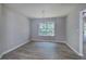 Bright dining room with hardwood floors, chandelier, large window and neutral paint at 121 Paradise Circle, Douglasville, GA 30134