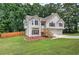 Charming split-level home featuring stone accents, wood shutters, and a two-car garage at 121 Paradise Circle, Douglasville, GA 30134