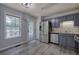 Well-lit kitchen featuring stainless steel appliances, gray cabinets, and modern flooring at 121 Paradise Circle, Douglasville, GA 30134