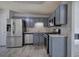 Updated kitchen features stainless steel appliances, gray cabinets, and modern flooring at 121 Paradise Circle, Douglasville, GA 30134