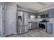 Modern kitchen features stainless steel appliances, gray cabinets, and modern flooring at 121 Paradise Circle, Douglasville, GA 30134