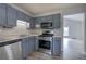 Charming kitchen featuring stainless steel appliances, gray cabinets and sleek countertops at 121 Paradise Circle, Douglasville, GA 30134
