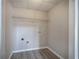 Laundry room with modern laminate flooring, light paint and a single shelf at 121 Paradise Circle, Douglasville, GA 30134