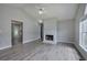 Bright living room with fireplace, ceiling fan, cathedral ceiling, and modern gray flooring at 121 Paradise Circle, Douglasville, GA 30134