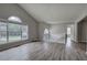 Spacious living room boasting cathedral ceilings, large windows, and modern gray flooring at 121 Paradise Circle, Douglasville, GA 30134