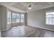 Spacious main bedroom showcasing a tray ceiling, ceiling fan and large windows at 121 Paradise Circle, Douglasville, GA 30134