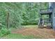 Spacious backyard with mature trees, a tiered deck, and ample room for outdoor activities at 3706 Londonderry Ct, Lithonia, GA 30038