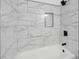 Beautifully tiled bathtub with a shelf and shower at 3706 Londonderry Ct, Lithonia, GA 30038