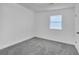 Clean and neutral bedroom with carpet, one window, and natural light at 3706 Londonderry Ct, Lithonia, GA 30038