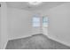 A well-lit empty bedroom with carpet and a window at 3706 Londonderry Ct, Lithonia, GA 30038