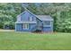 Charming two-story home with blue siding, landscaped front yard, and inviting front porch at 3706 Londonderry Ct, Lithonia, GA 30038