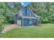 Beautiful two-story home featuring blue siding, a well-manicured lawn, and an attached garage at 3706 Londonderry Ct, Lithonia, GA 30038